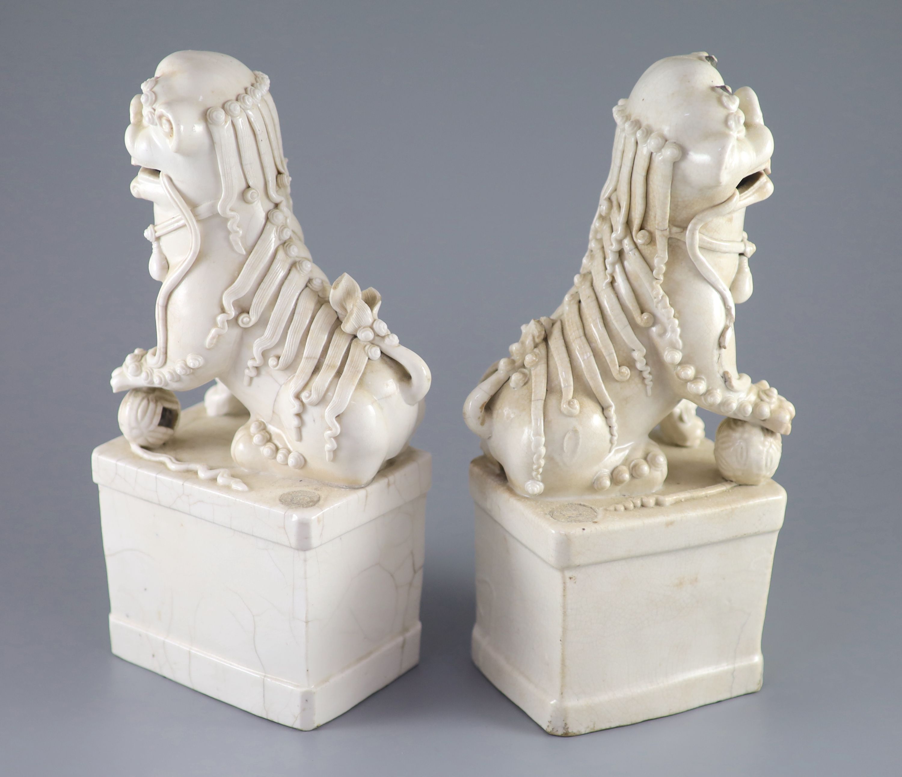 A pair of Chinese Dehua Blanc de chine kylin joss stick holders, some cracks. 26cms